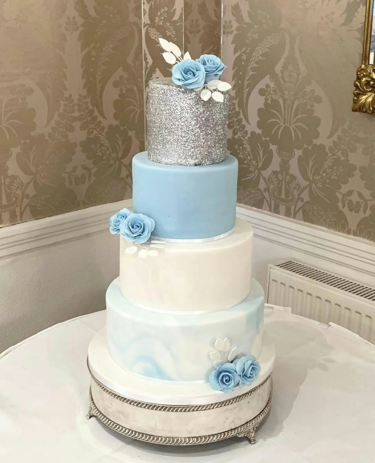 Wedding cake with silver, blue, white and marble layers
