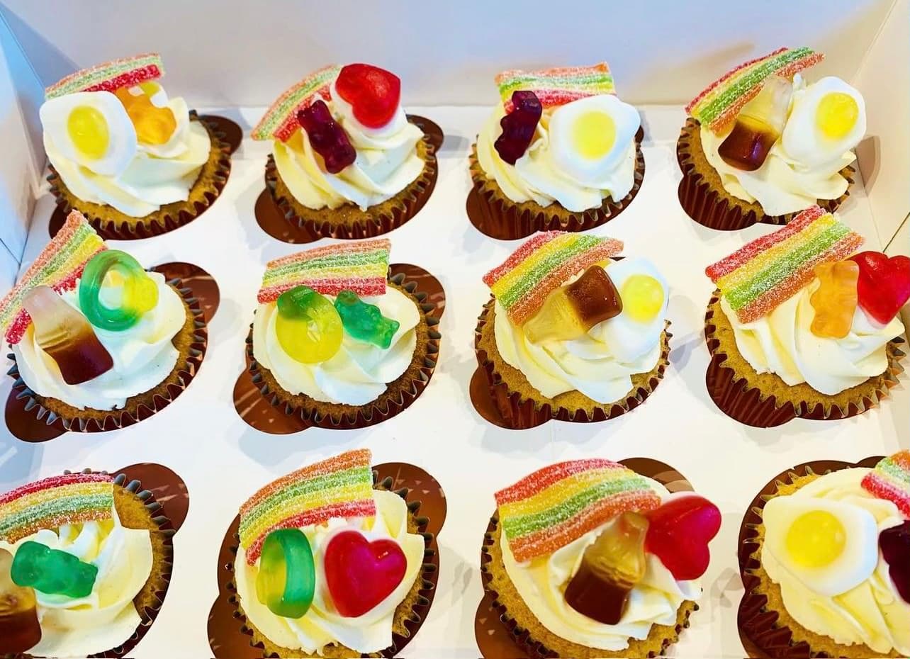 White frosted cupcakes with haribo sweets on top